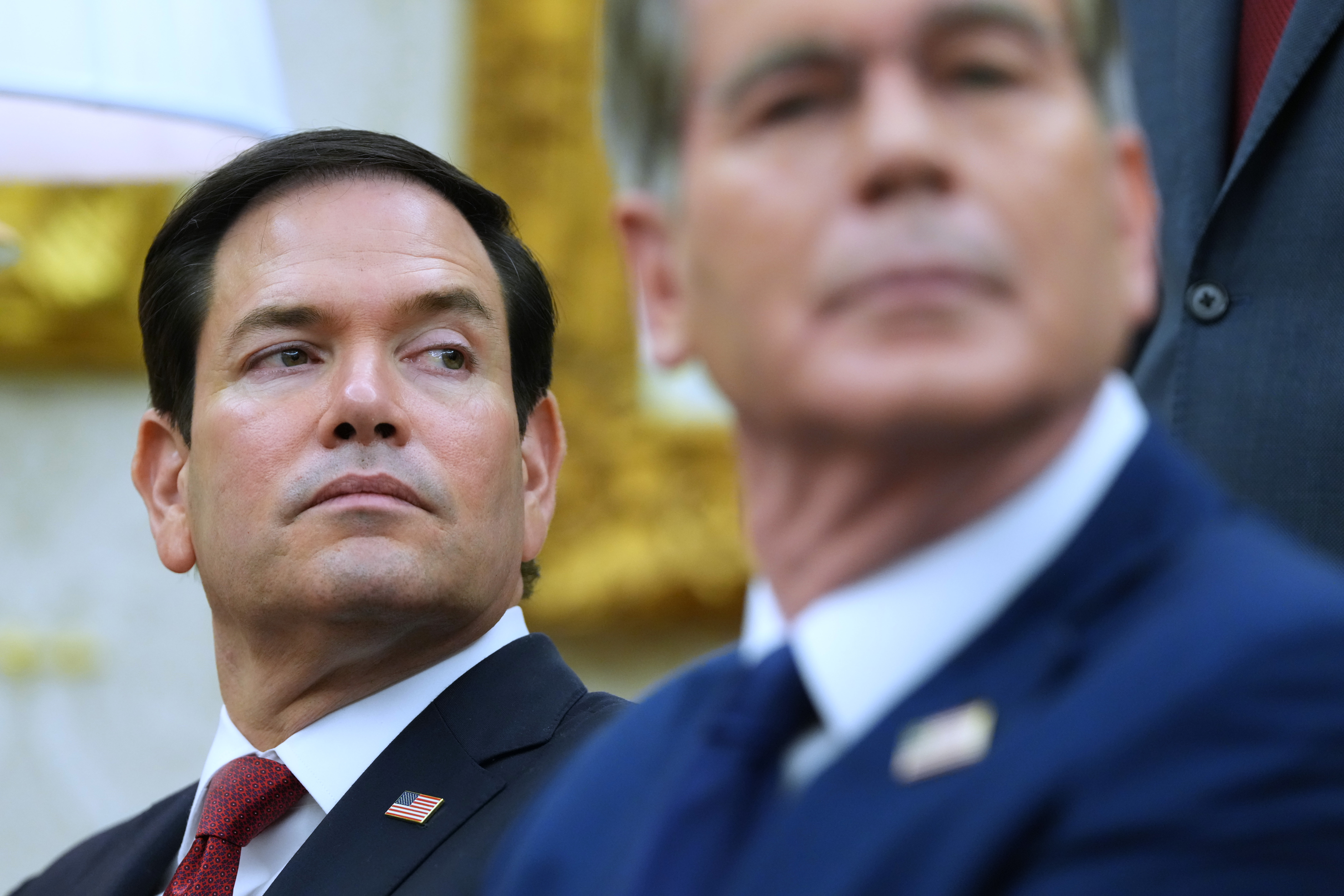 Secretary of State Marco Rubio, left, listen as President Donald Trump meets with Iraq